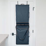 Blue hanging Convertible Laundry Hamper bag on a white door