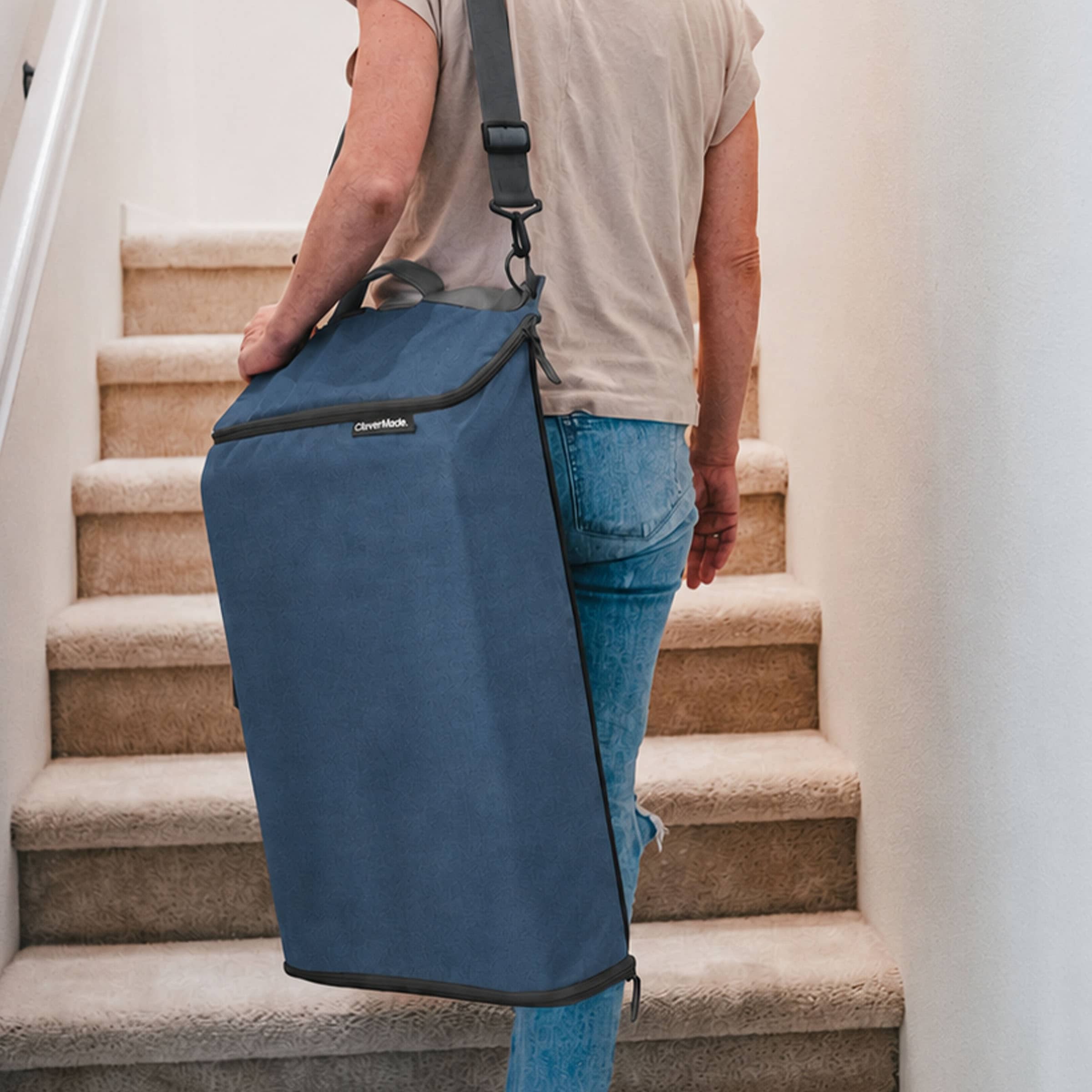 Person carrying a blue bag up a set of stairs