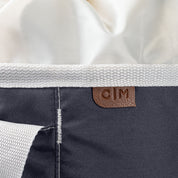 Close-up of a laundry backpack duffel bag with a visible brand label C|M on a white background