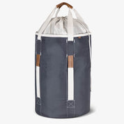 Gray laundry backpack duffel bag with white drawstring top and brown handles on a white background