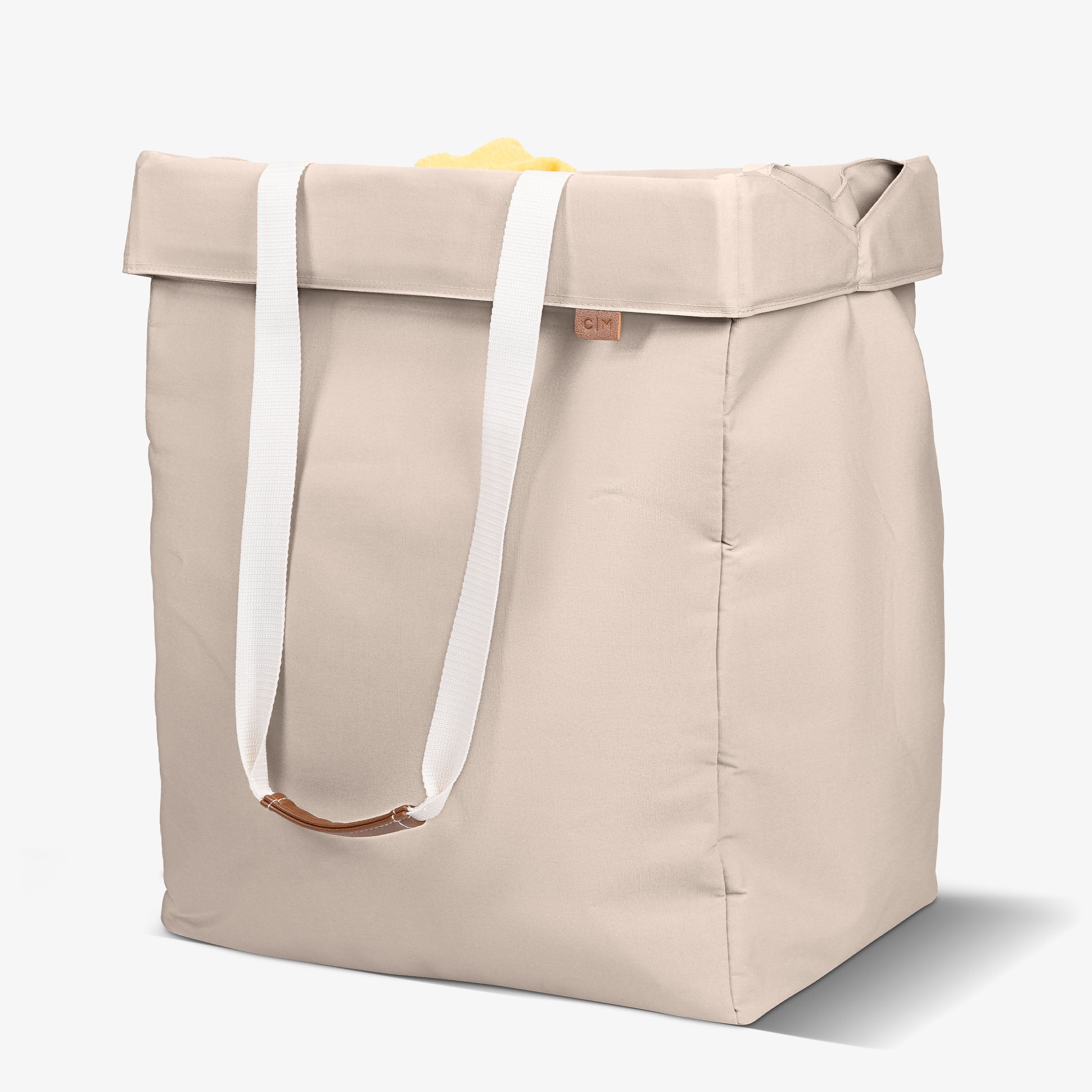 Cream tote bag with handles on a white background