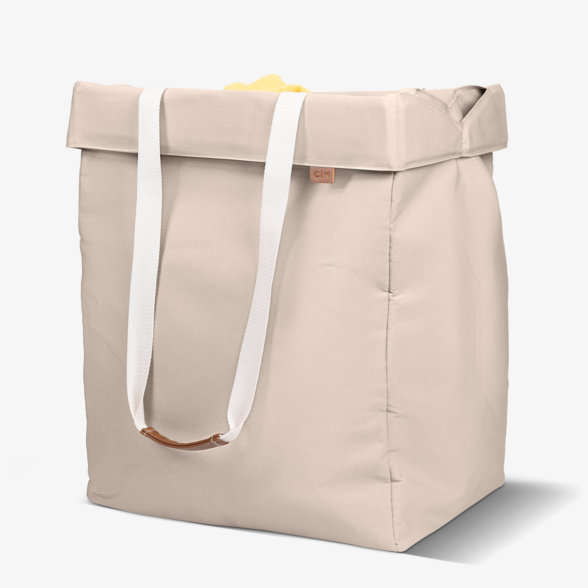 Cream tote bag with handles on a white background
