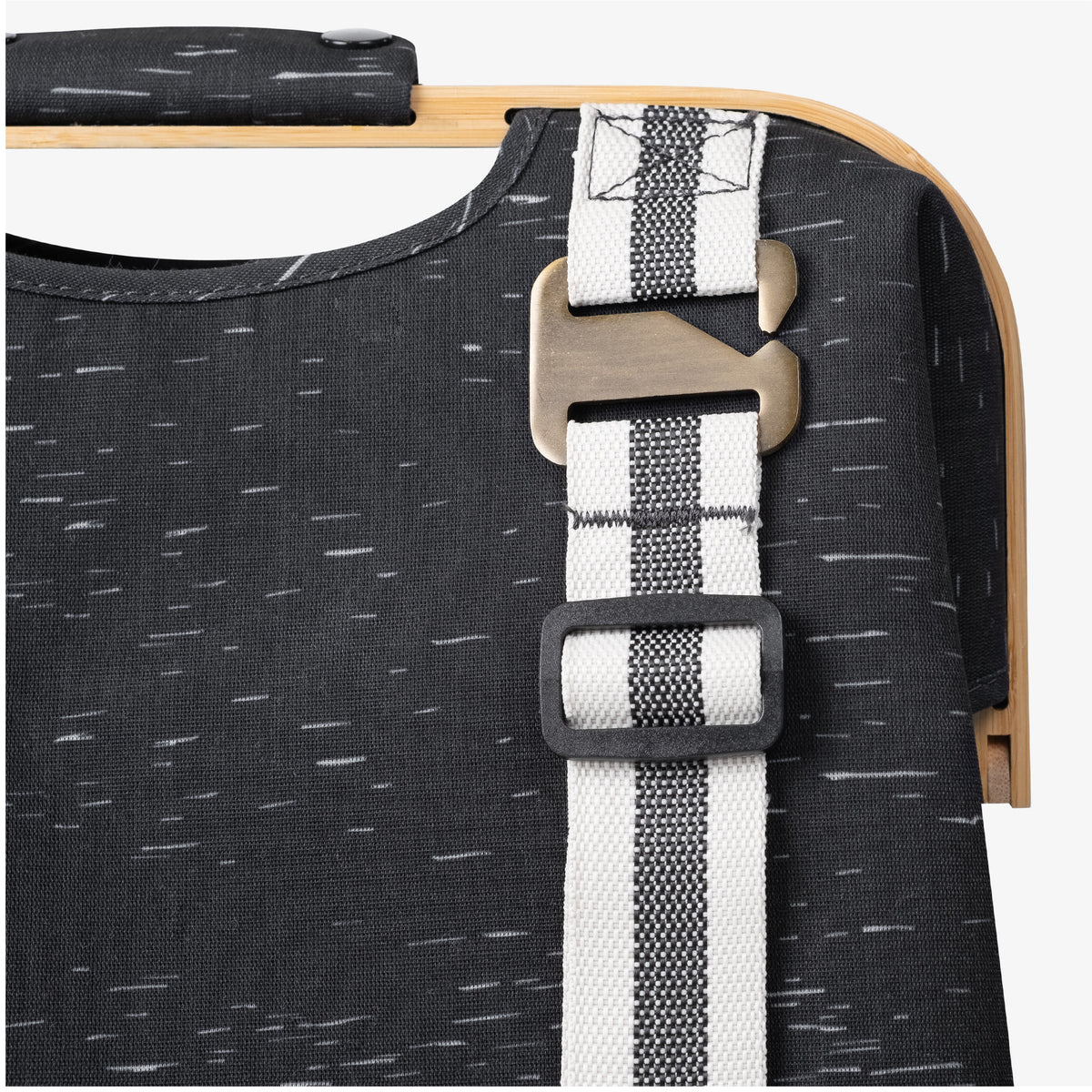 Close up of reinforced straps and hardware of CleverMade laundry backpack LUXE