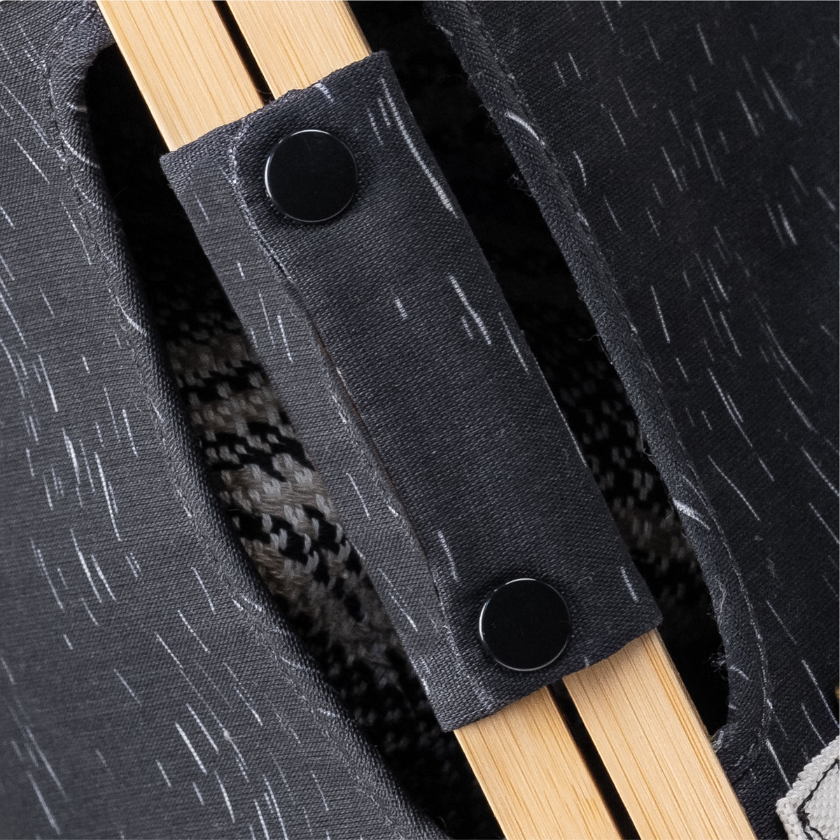 Close up of wooden handle of CleverMade laundry backpack LUXE