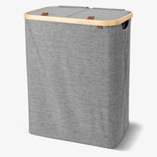 Gray laundry basket with wooden handle on a white background