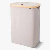 Cream laundry basket with wooden handle on a white background
