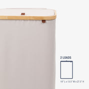 Cream laundry basket with wooden handle and dimensions on a white background