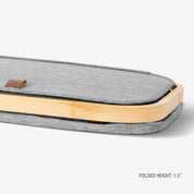 Gray carrying case with wooden accents on a white background