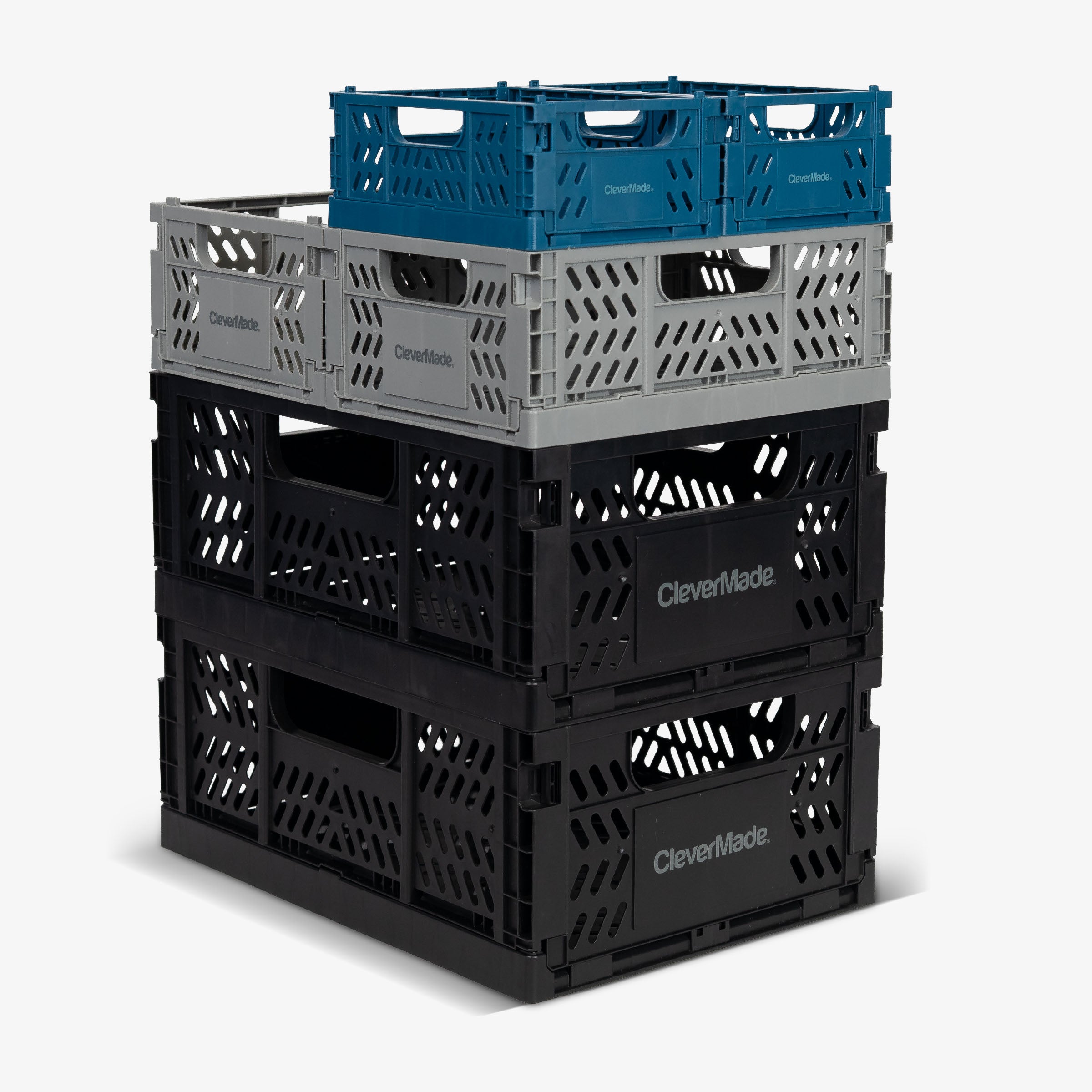 Stack of CleverMade mini collapsible storage crates in gray, black, and blue on a white background