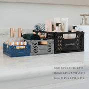 Three mini collapsible storage crates
 in different sizes on a countertop with product display.