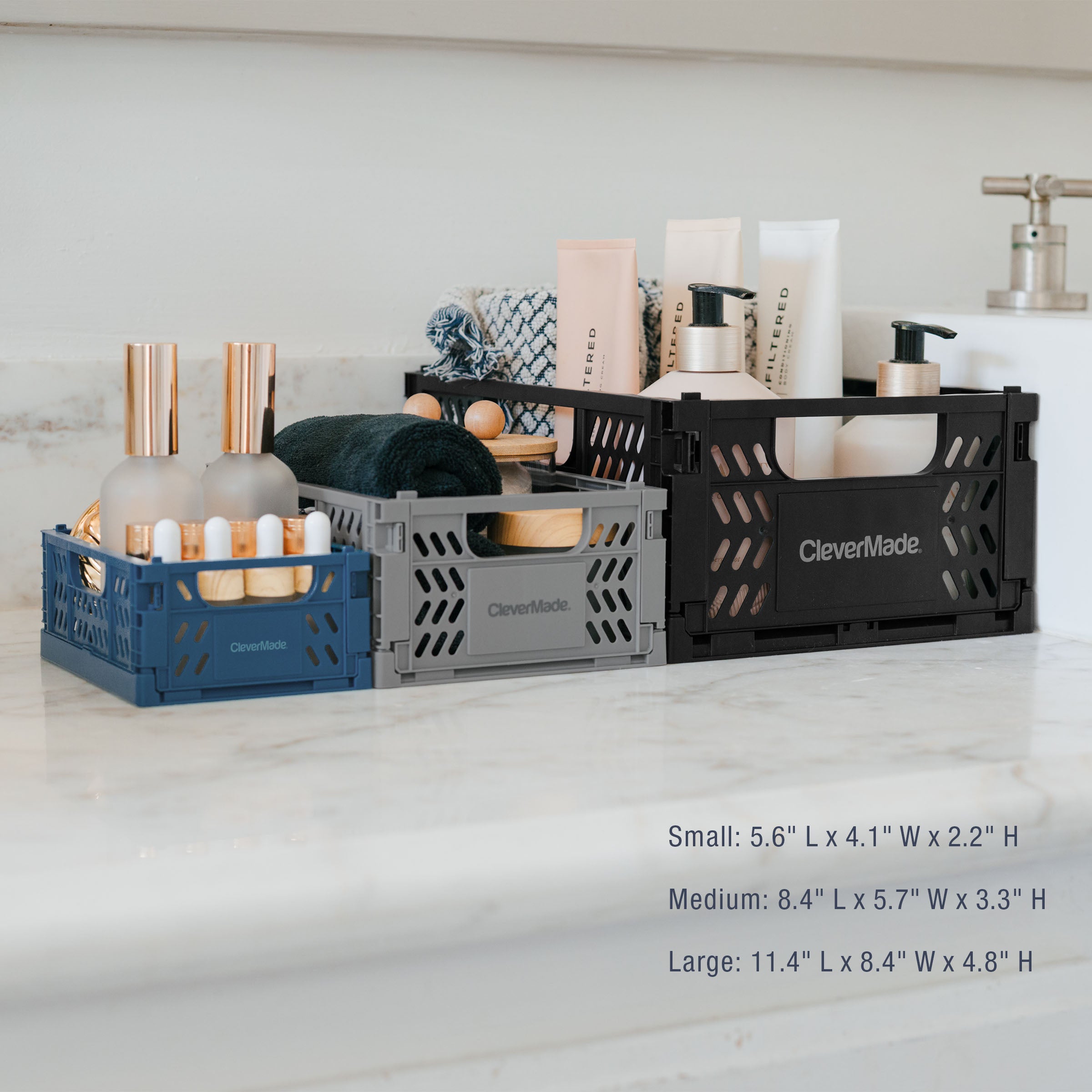 Three mini collapsible storage crates
 in different sizes on a countertop with product display.