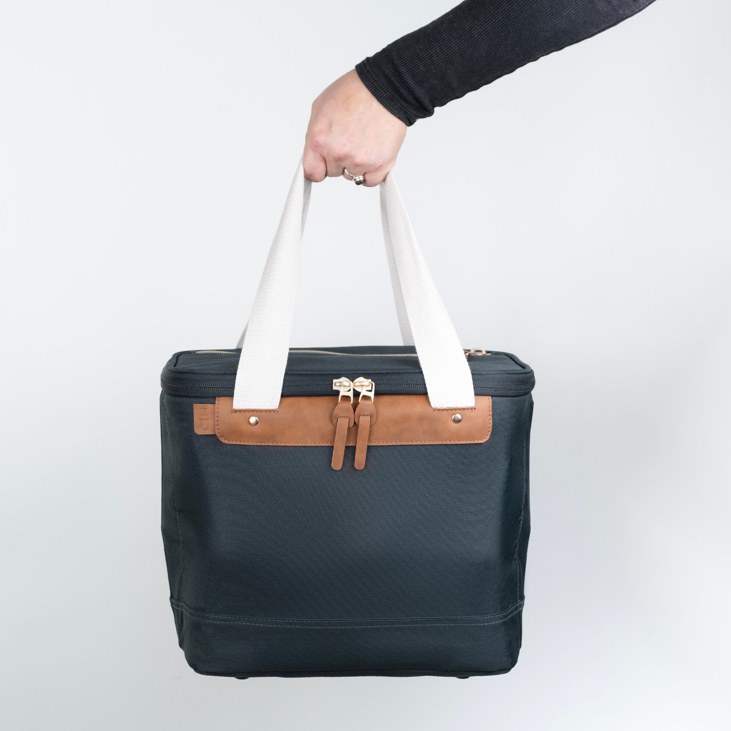 Malibu collapsible cooler bag with navy blue body, brown leather accents, and white straps.
