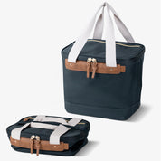 Malibu collapsible cooler bag with navy blue body, brown leather accents, and white straps.