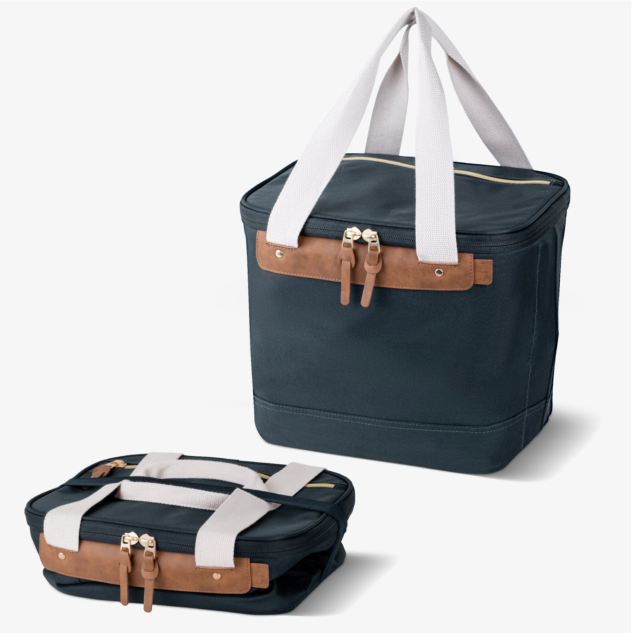 Malibu collapsible cooler bag with navy blue body, brown leather accents, and white straps.