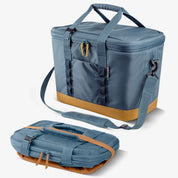 Blue cooler bag with brown base and straps on a white background