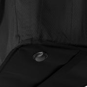 Close-up of a black textured surface with a metallic button.
