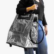 Lady Carrying 62L Silver Rolling Hauler Bag  on her Shoulder
