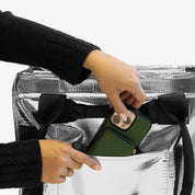 Placing Phone on 62L Silver Rolling Hauler Bag Pocket