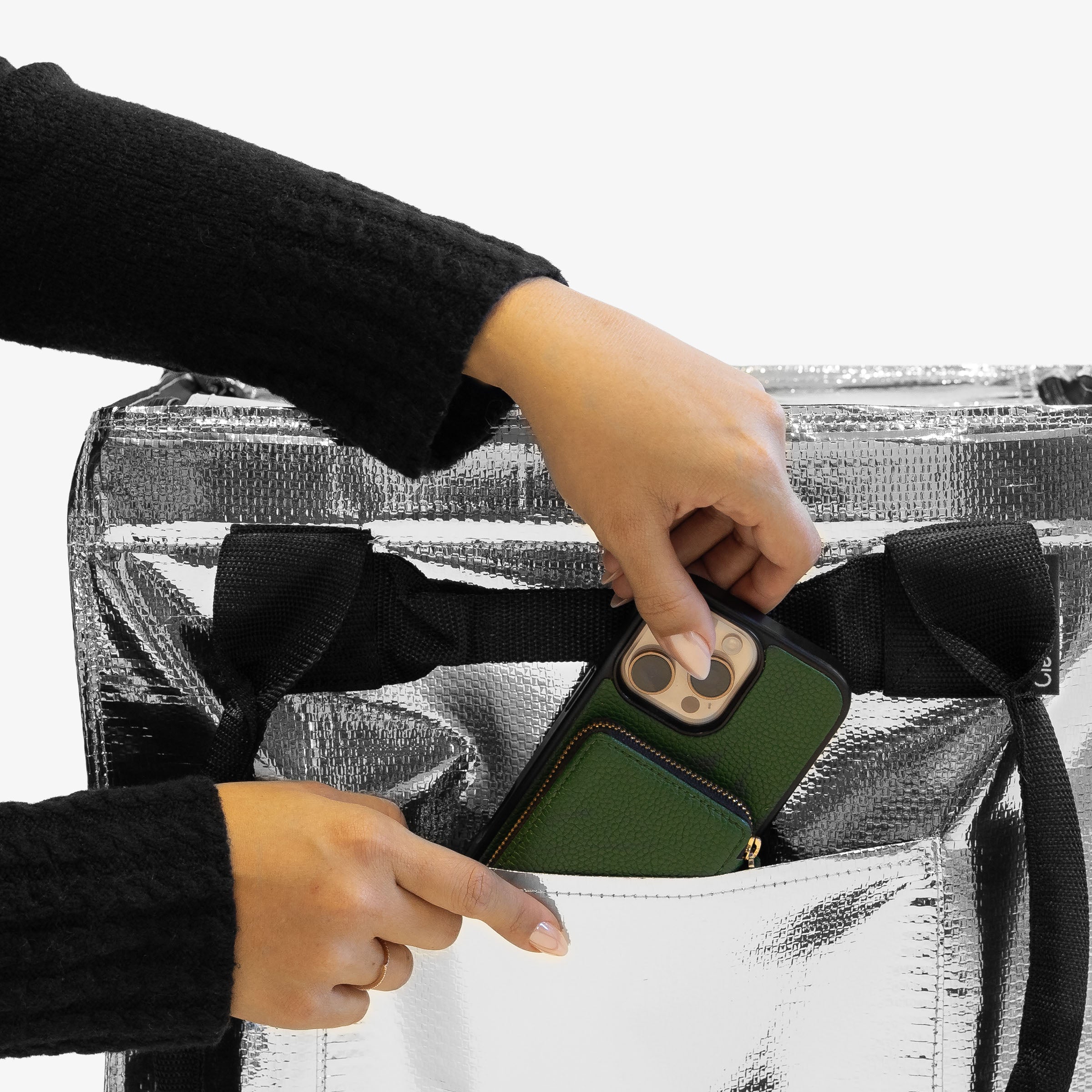 Placing Phone on 62L Silver Rolling Hauler Bag Pocket