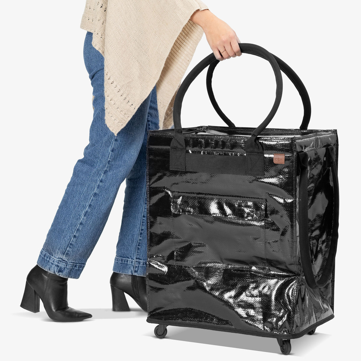 Person holding a black suitcase with a white background