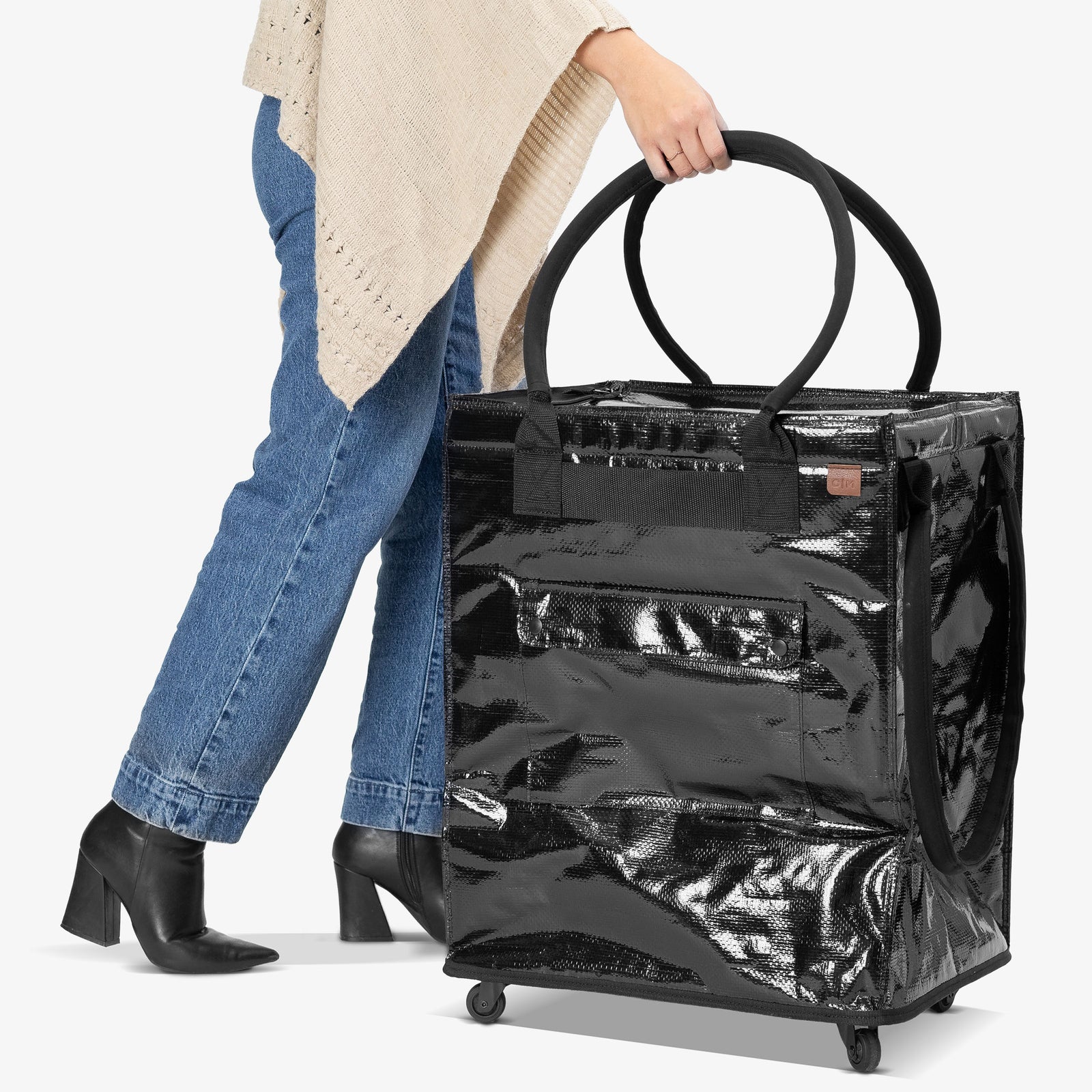 Person holding a black suitcase with a white background