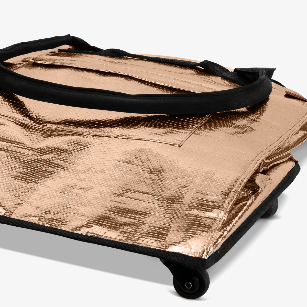 Metallic gold bag with black handle on a white background