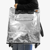 Lady Carrying Silver Rolling Hauler Bag