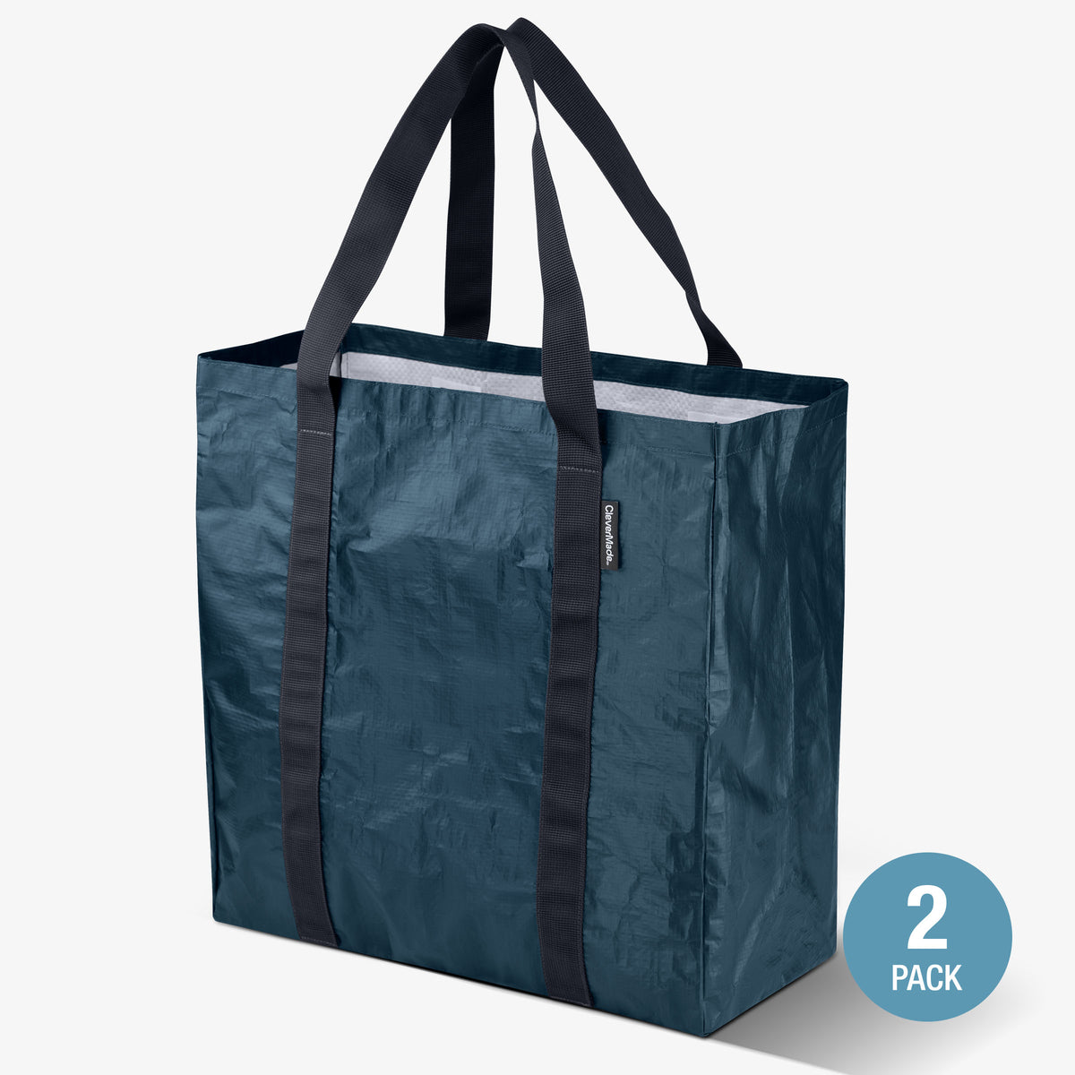 Blue reusable storage tote bag with black handles on a white background