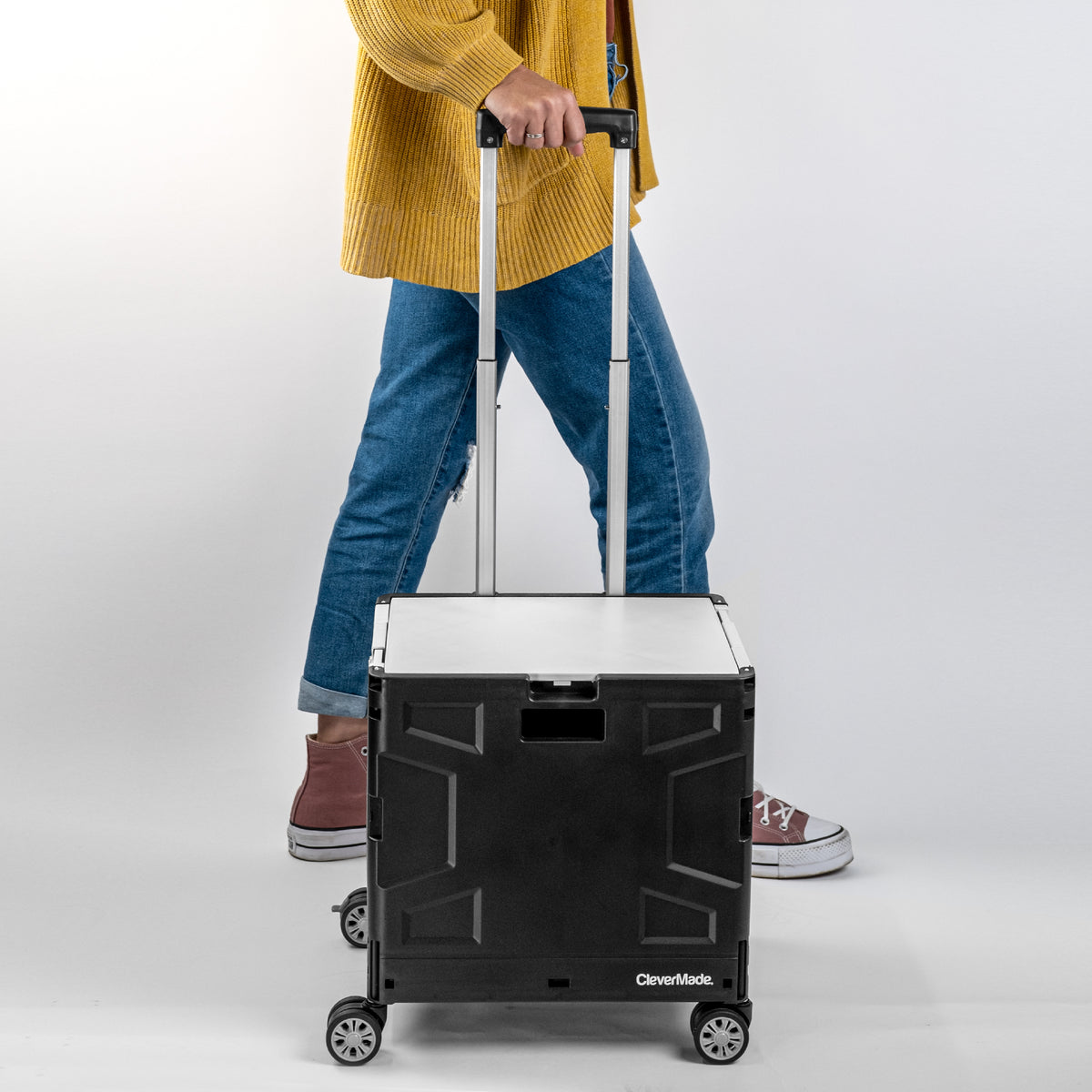 Person holding the collapsible wheeled crate with four wheels