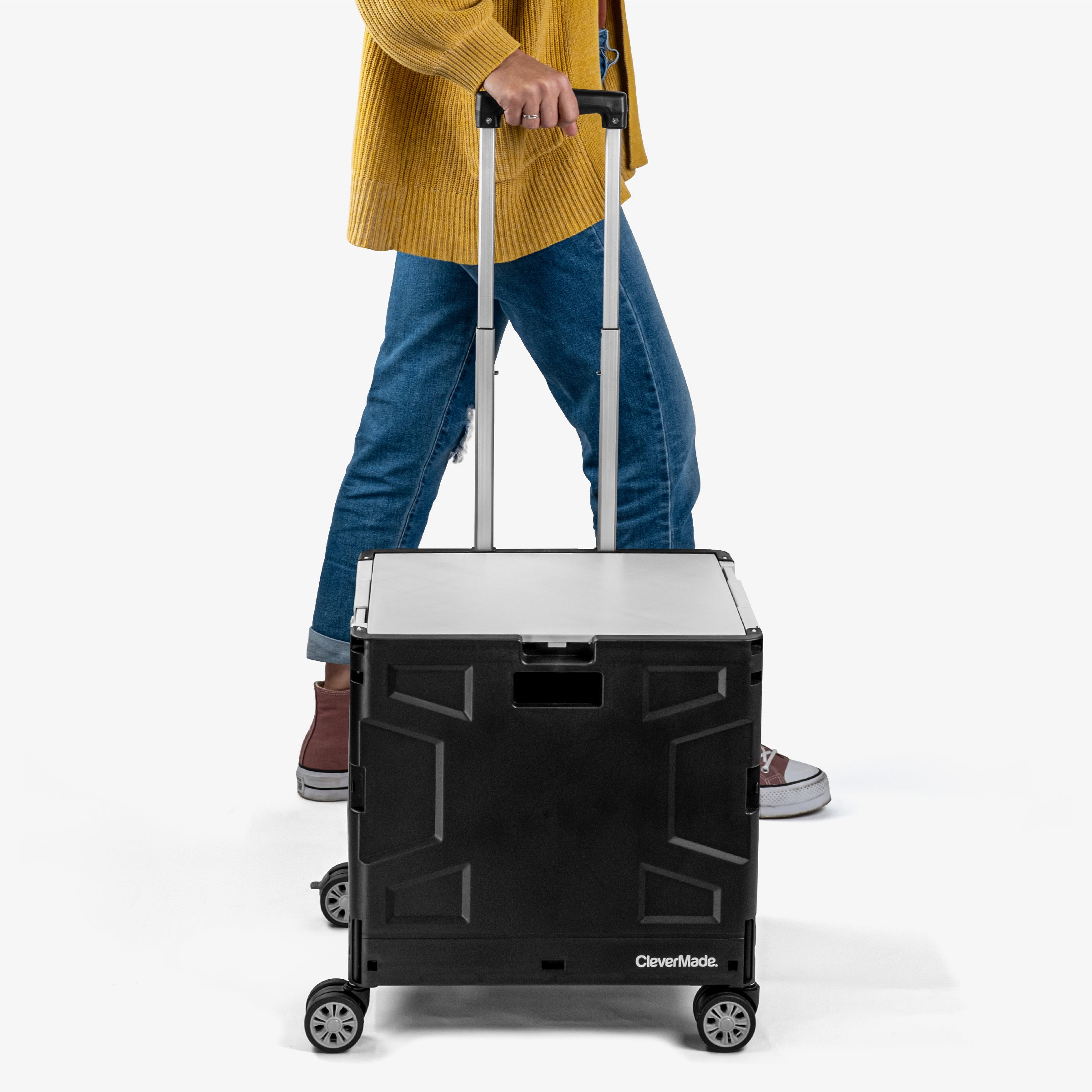 Person holding the collapsible wheeled crate with four wheels